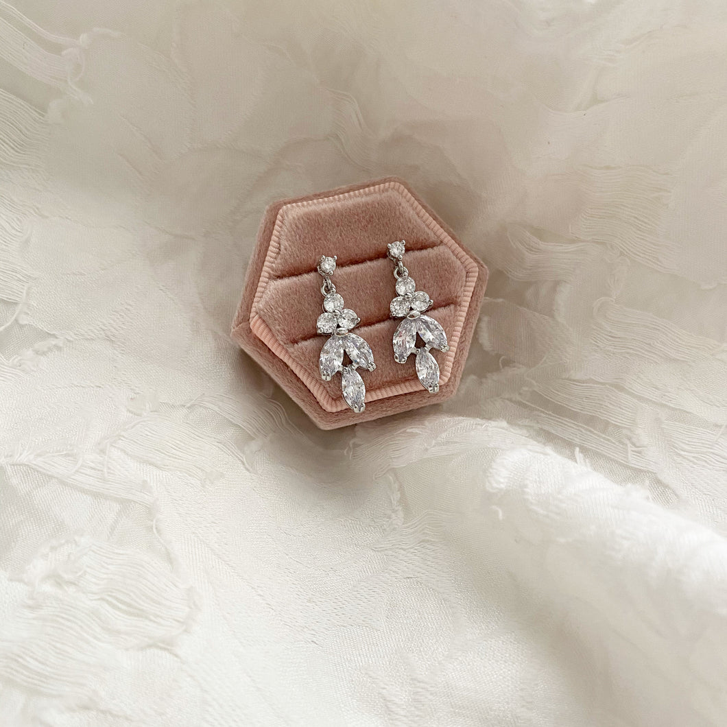 Delicate drop earrings for bride on a blush pink ring box 